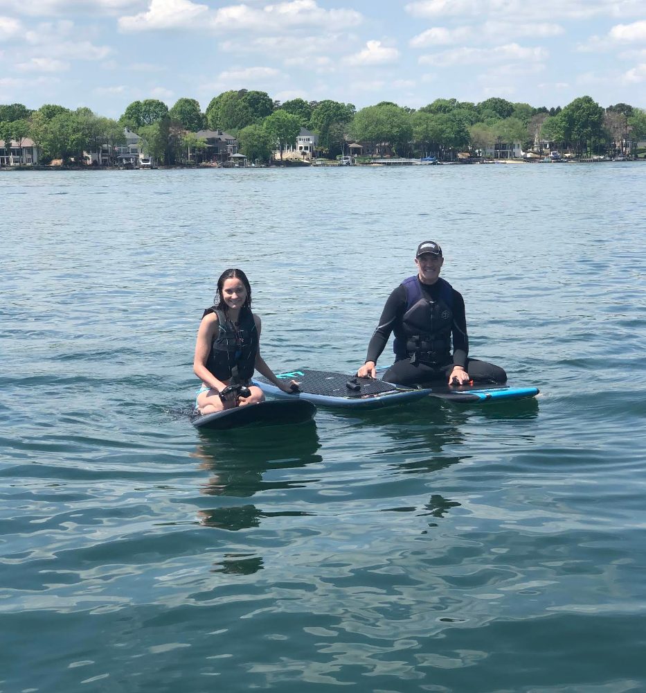 Two riders sitting on their eFoils on Lake Norman